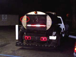 Vacuum truck with bumper sticker